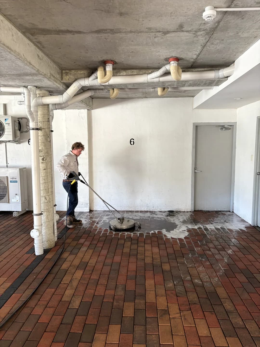 Two-storey home exterior washed, white walls restored from grey dirt stains